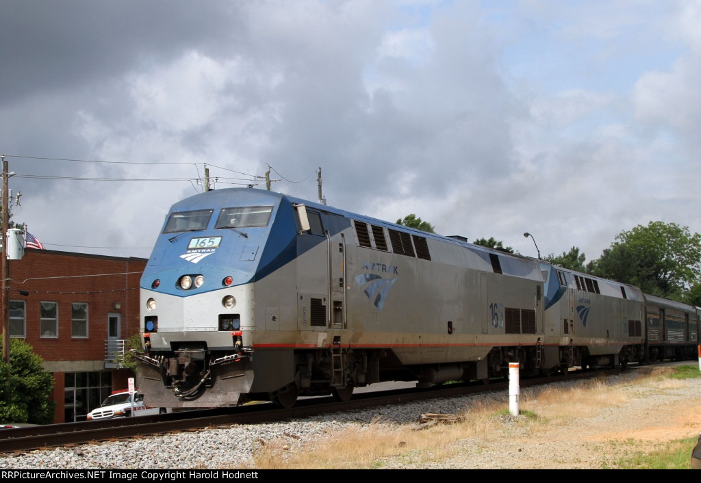 AMTK 165 leads train P092 away from the station